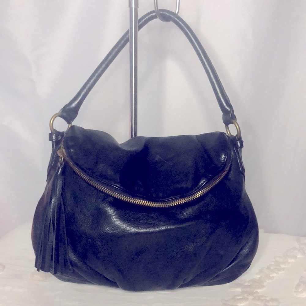 MARGOT black genuine leather hobo style handbag with tassel. Brass hardware.